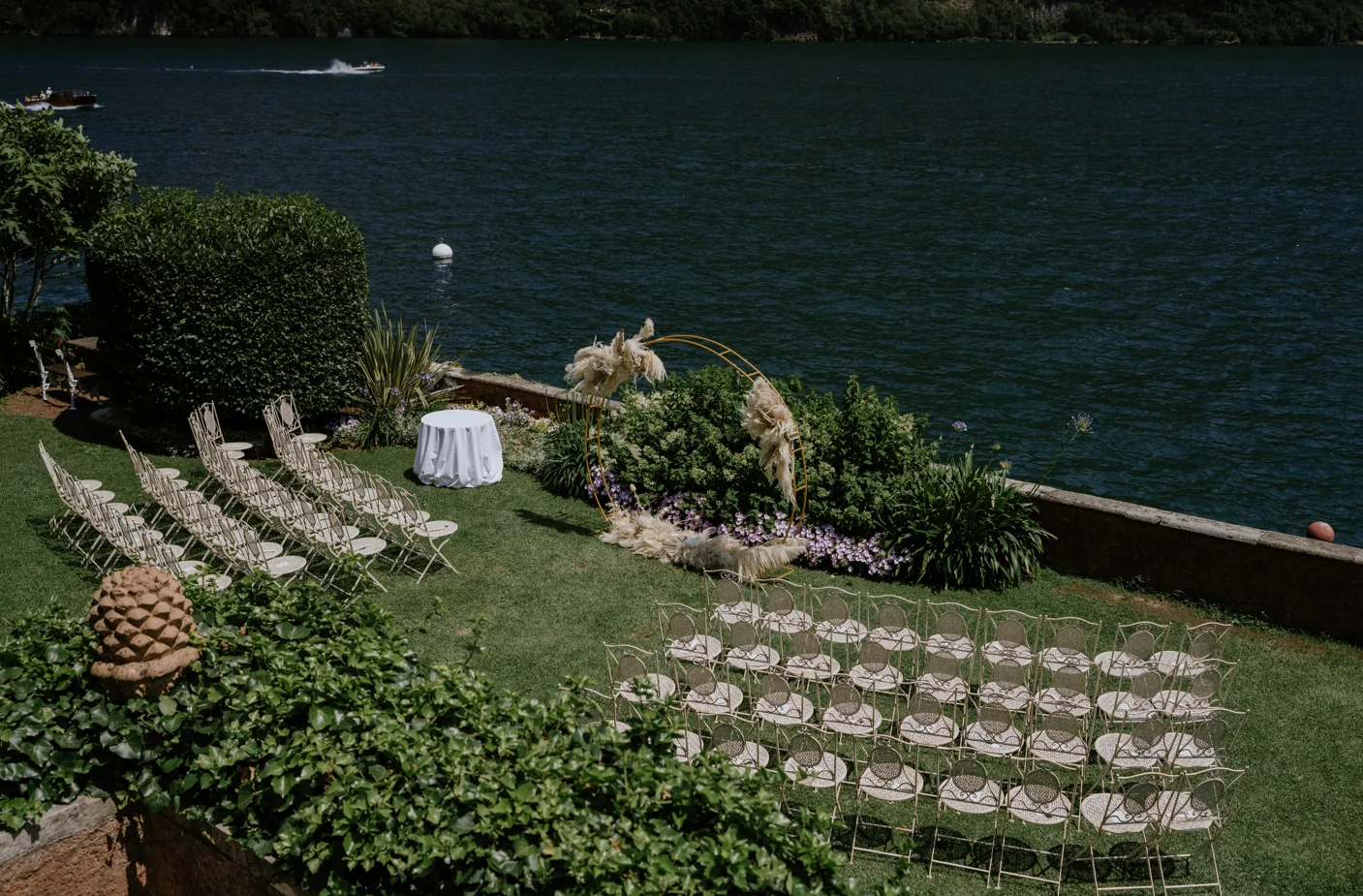 A lakeside wedding ceremony surrounded by flowers